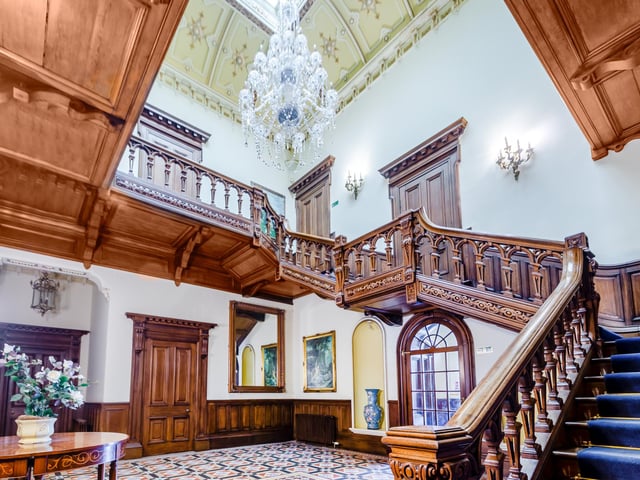 A very impressive staircase and chandelier in this grand hallway.