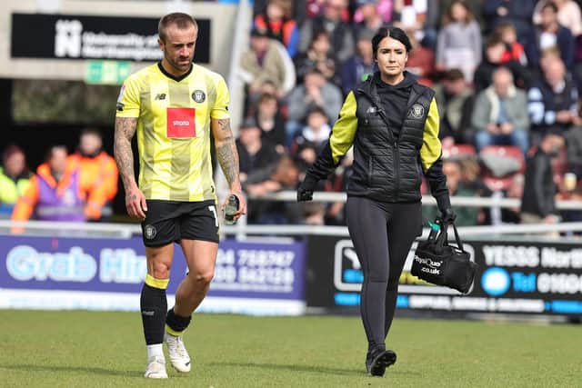 Harrogate Town midfielder Alex Pattison leaves the pitch alongside physio Rachel McGeachie having suffered a calf injury during Saturday's League Two loss at Northampton Town. Picture: Pete Norton/Getty Images.