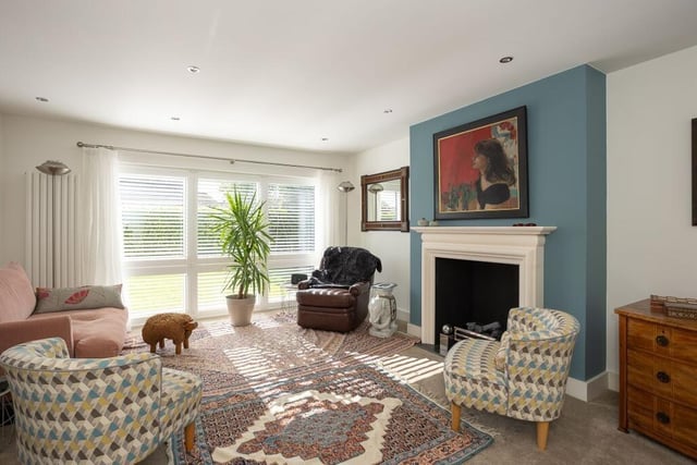 A reception room with feature fireplace.