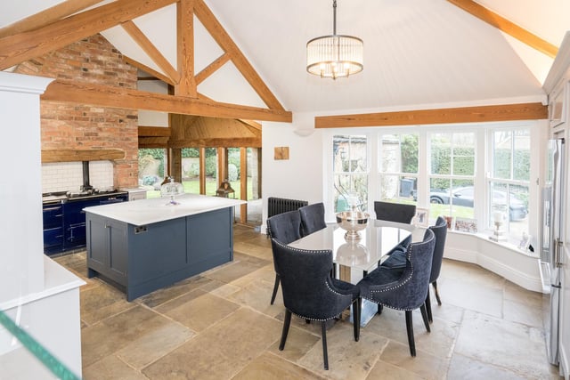 The open plan kitchen and diner with ceiling beams.