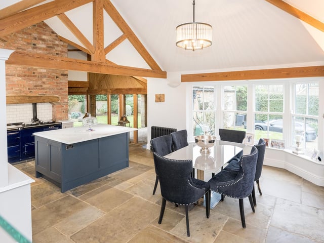 The open plan kitchen and diner with ceiling beams.