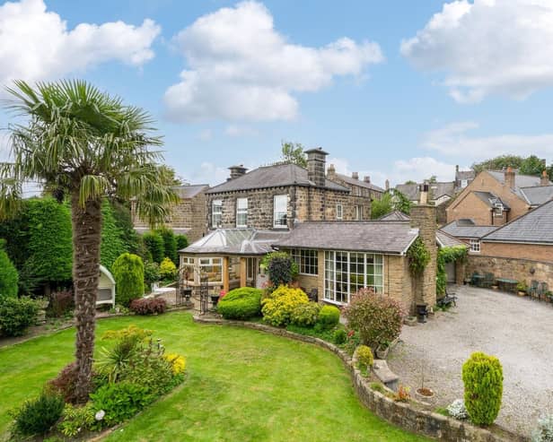 The stunning property has a large driveway and walled gardens.