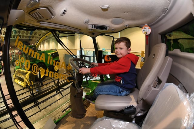 Pictured: Six year old Harrison Pyle in the drivers seat of a giant combine harvester.