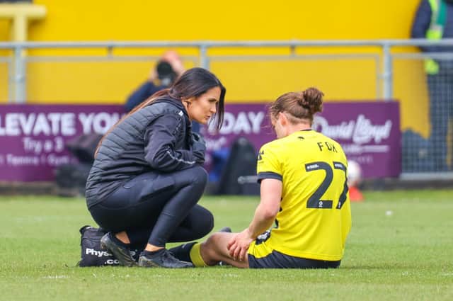 Harrogate Town midfielder Ben Fox receives treatment from physio Rachel McGeachie during Saturday's 3-1 home defeat to Notts County. Picture: Matt Kirkham