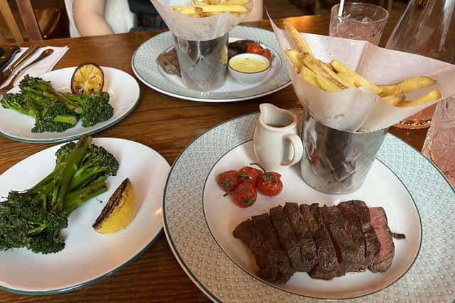 The 8oz flat iron steak served with fries, roasted vine tomatoes, tenderstem broccoli and peppercorn sauce
