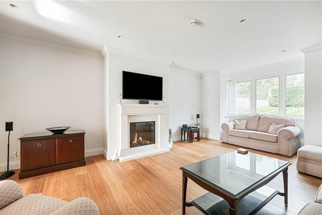 A light and spacious sitting room, with feature fireplace.