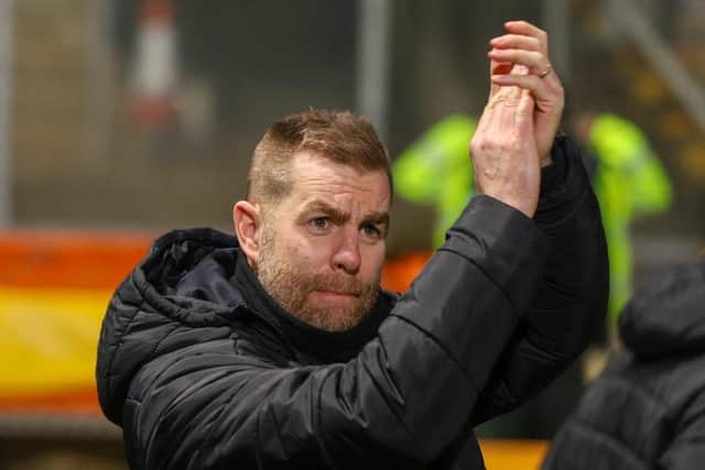 Simon Weaver applauds Harrogate Town's travelling fans following his side's narrow defeat at Valley Parade.
