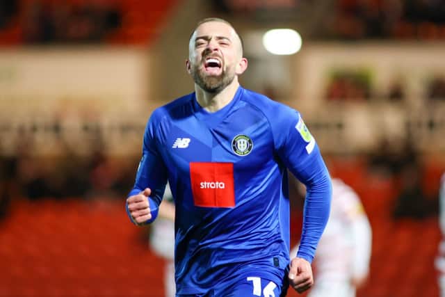 Alex Pattison celebrates after firing Harrogate Town into a 2-0 lead against Doncaster Rovers.