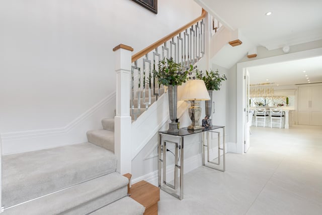 The spacious entrance hall with staircase up leads on to the living kitchen.