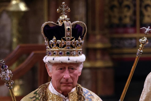 King Charles III walks wearing St Edward's Crown during the Coronation Ceremony inside Westminster Abbey.