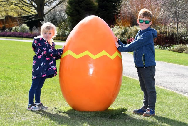 Cerys Clitheroe (aged four) and her older brother Ethan Clitheroe (aged seven) with one of the giant eggs on display
