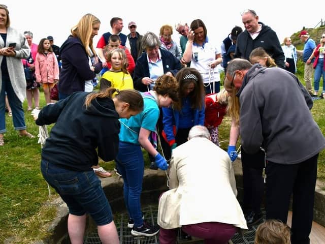 Time capsule being lowered into the well at Sandal Castle