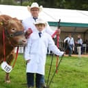 Pictured: Thor Atkinson and his son nine year old sone Frankie Atkinson with their prize winning British Blonde called Plato.