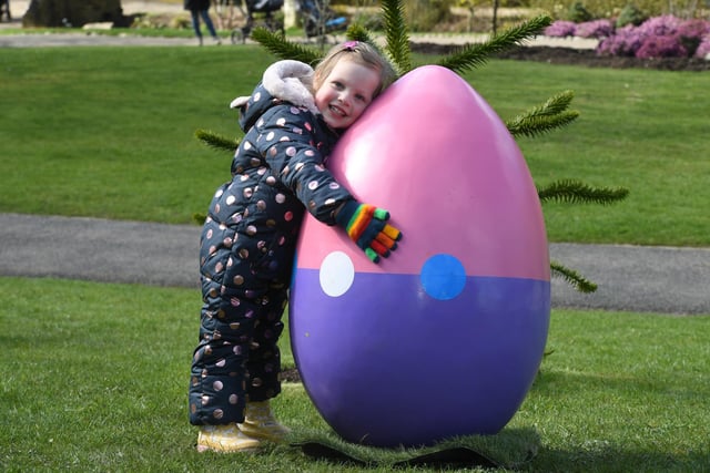 Harriet Smith (aged three) giving one of the giant eggs a hug