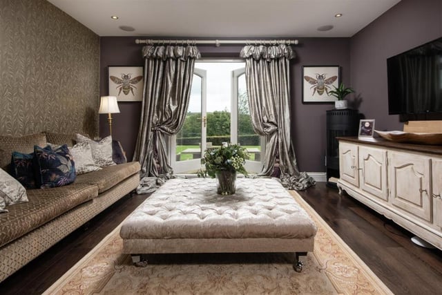 A television room that again has doors out to the patio and garden.