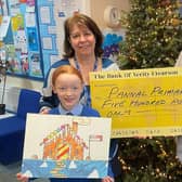 Lyndsay Snodgrass, right, presenting a cheque for £500 to Mrs Jane Turner, Headteacher at Pannal Primary School, and overall winner Pippa Ridgard