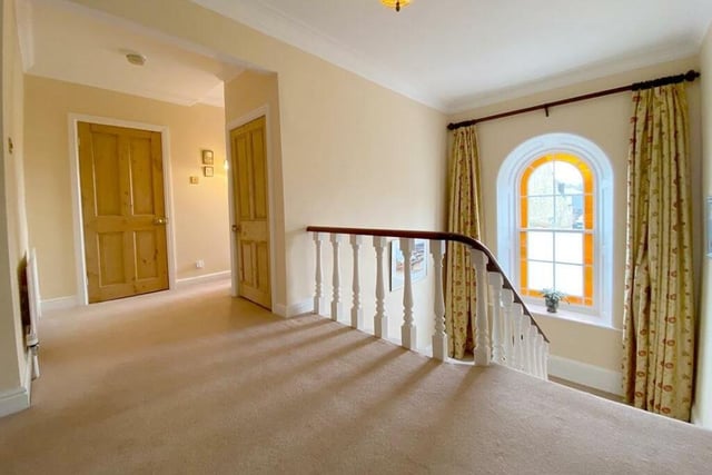 The gallery landing with feature arched window on the staircase.