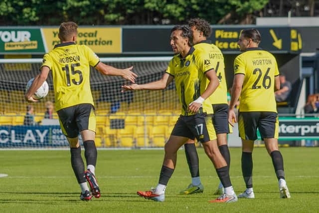 Josh Hmami, centre, is congratulated by team-mate Bailey Hobson after finding the net against Gateshead during Harrogate Town's Bank Holiday Monday victory at Wetherby Road. Pictures: Harrogate Town AFC