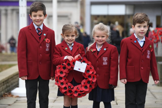 Pupils from Belmont Grosvenor School with their wreath at the  Remembrance Day parade and service at the cenotaph