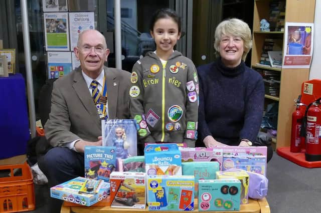 Knaresborough Brownie  Annabelle (centre) with Knaresborough Rotary President David Kaye (left) and project co-ordinator Rotarian Debbie Wilson (right) and the toys collected by Annabelle.