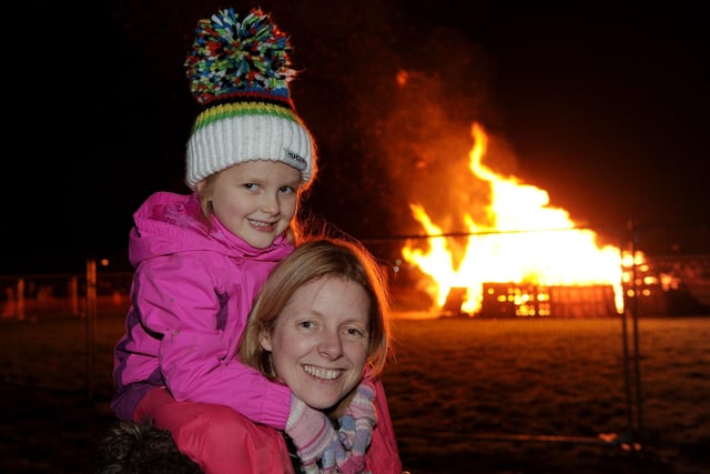 Charlotte Miles (aged 4) with her mum Heather watching Charlotte's dad light the bonfire at the Harrogate Stray Bonfire in 2019