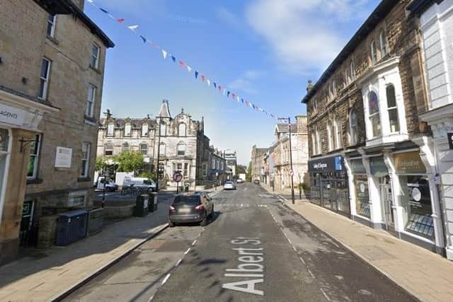 A number of streets in Harrogate were forced to close for several hours on Friday after a man was found on a roof