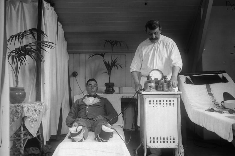 A patient recuperating in the spa town of Harrogate is wired up to an electric machine used for the cure of frostbite and rheumatism in 1910.