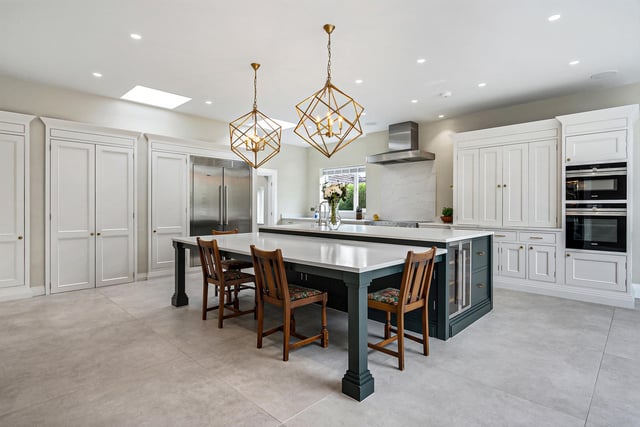 A different aspect of the kitchen with its solid wood units with quartz worktops, and integrated appliances.