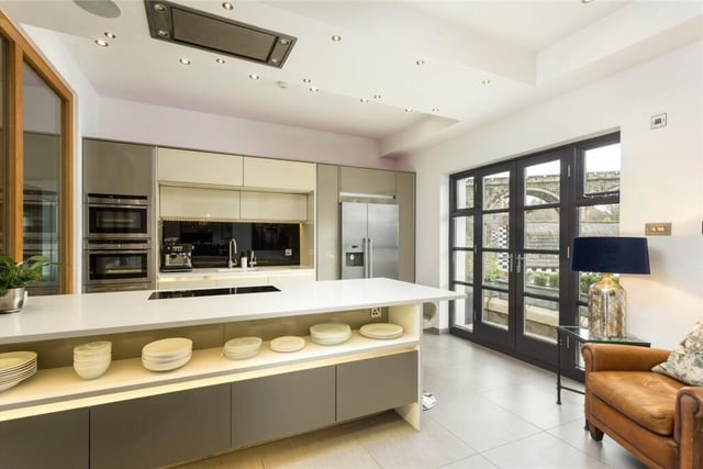 The contemporary kitchen has fitted units, and underfloor heating.