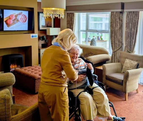 residents and guests enjoying one another's company whilst knitting