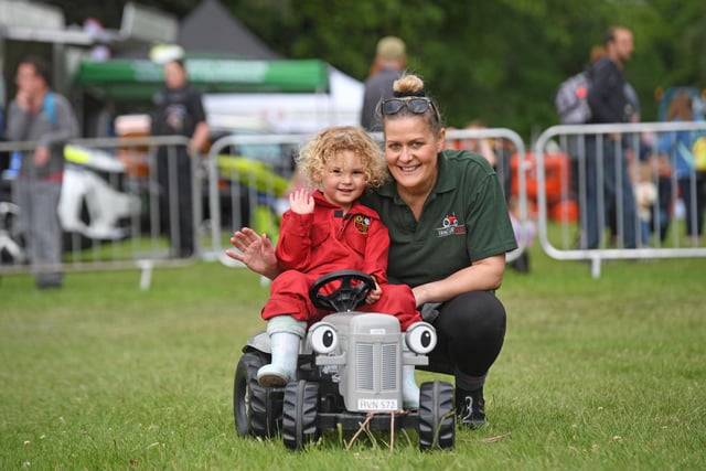 A youngster takes to the wheel of a mini tractor at the festival