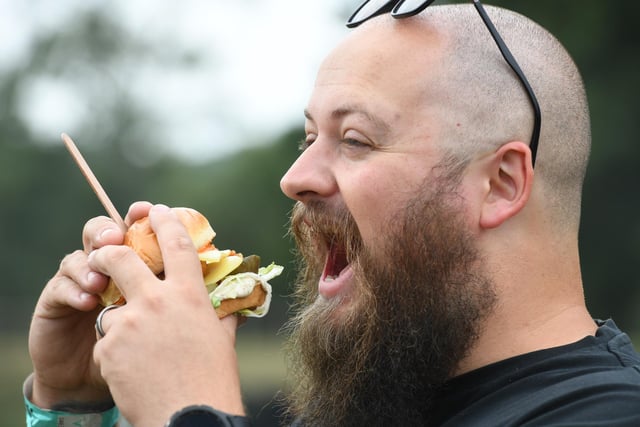 Jonathon Saunders of Caps Off Kitchen tucks into a double chicken burger