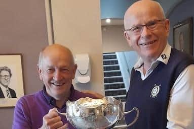 Mike Starkings receives the 2022 Barber-Bratby Trophy from Pannal Golf Cub Chairman David Howes.