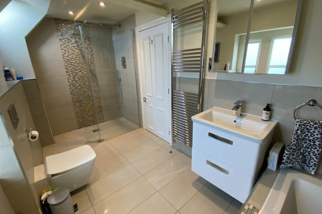 A modern and stylish bathroom with walk-in shower unit.