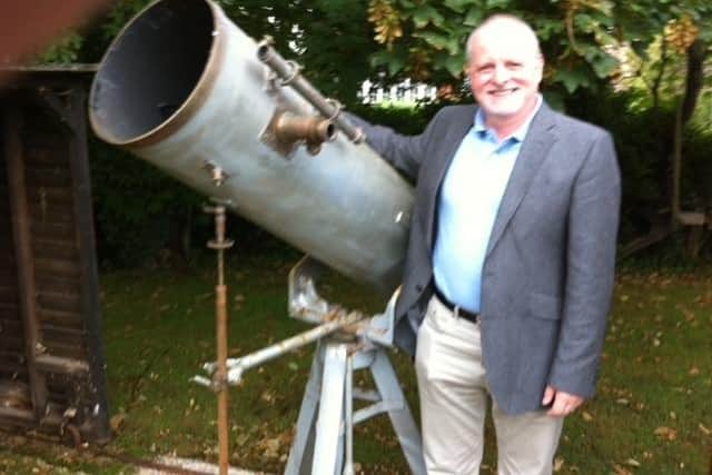 Dr Keith Souter with Sir Patrick Moore's telescope.