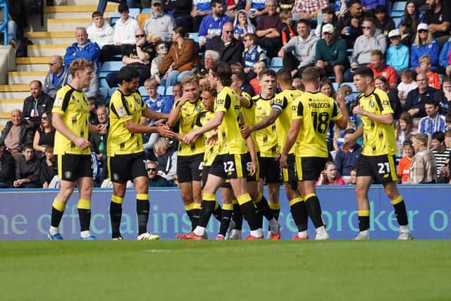 Harrogate Town's players celebrate after Stephen Duke-McKenna handed them a 16th-minute lead against Gillingham.