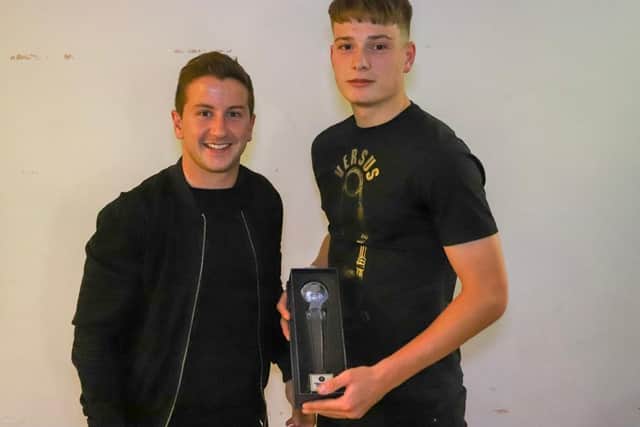 Daniel Nimick is presented with Harrogate Town Under-19s' 2018/19 manager's player of the season award by Josh Falkingham.