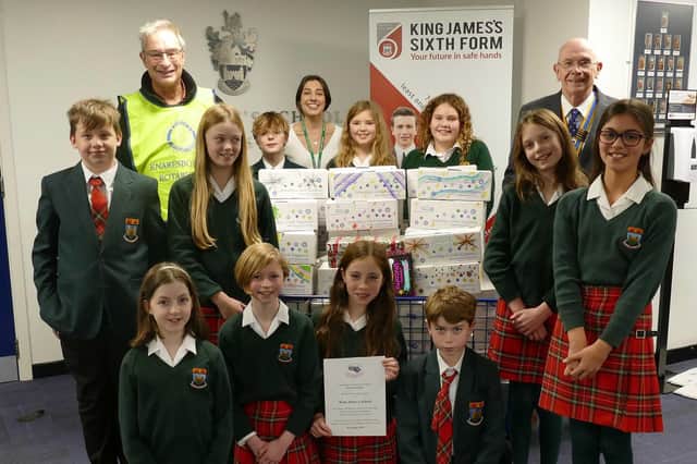 King James’s School, Knaresborough Year 7 pupils and Business Services Assistant Phoebe Logan, present their filled shoeboxes to Rotary President, David Kaye, and Shoebox co-ordinator Rotarian David Druett.