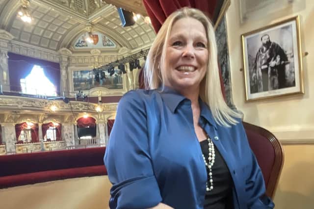 Lucy Fox, the new Vice President of the Royal Hall Restoration Trust, sitting in the box at the Royal Hall with a photograph of 19th century Harrogate Mayor Samson Fox and Samson’s biography. (Picture contributed)