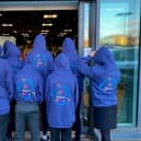Ready yo help in the newYMCA Charity shop in Ripon - young people model hoodies donated by the Masonic Lodge