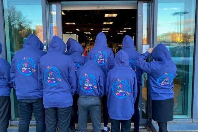 Ready yo help in the newYMCA Charity shop in Ripon - young people model hoodies donated by the Masonic Lodge