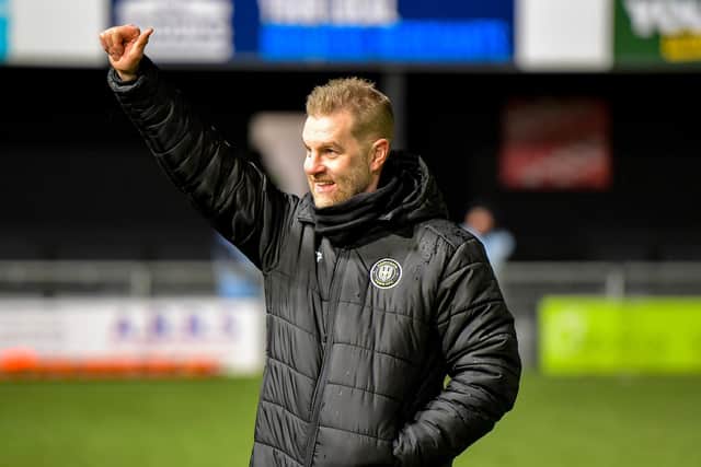 Harrogate Town manager Simon Weaver salutes the home faithful following his side's dramatic Boxing Day success over Grimsby Town at Wetherby Road.