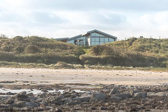 The property enjoys a truly magnificent position set back into the dunes on the road between Beadnell and Seahouses.