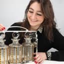 Julia Matyear, cataloguer and valuer at Elstob Auctioneers, pictured with the Art Deco silver tantalus engraved ‘To Basil with love from Gracie’ ahead of the auction on April 10