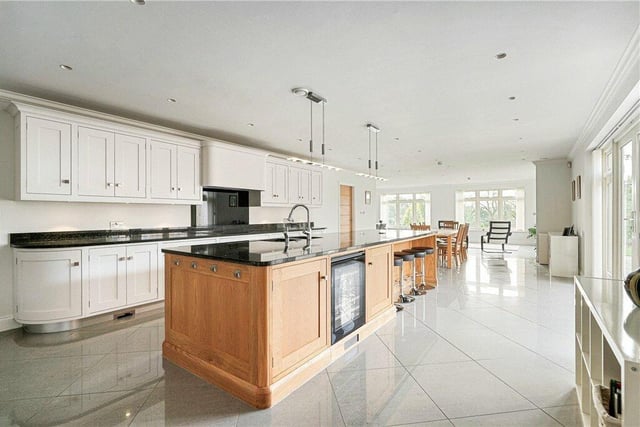 A magnificent high spec kitchen with extensive fitted units, and a central island.