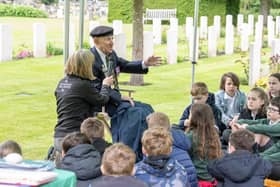 Harrogate youngsters from Willow Tree Community Primary School listen to York's remaining D-Day veteran Ken Cooke at the Commonwealth War Graves Commission site at Stonefall Cemetery in Harrogate,. (Picture Tony Johnson)
