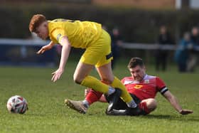 Tadcaster Albion midfielder Sam Kitchen is felled by Knaresborough Town's Ben Parkes. Pictures: Gerard Binks