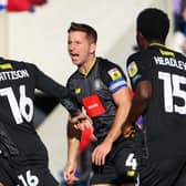 Harrogate Town captain Josh Falkingham, centre, congratulates team-mate Alex Pattison after he found the net during last weekend's 2-1 loss at Colchester United. Pictures: Matt Kirkham