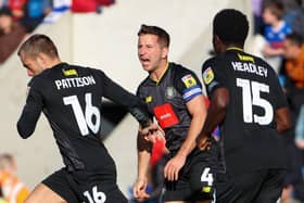 Harrogate Town captain Josh Falkingham, centre, congratulates team-mate Alex Pattison after he found the net during last weekend's 2-1 loss at Colchester United. Pictures: Matt Kirkham