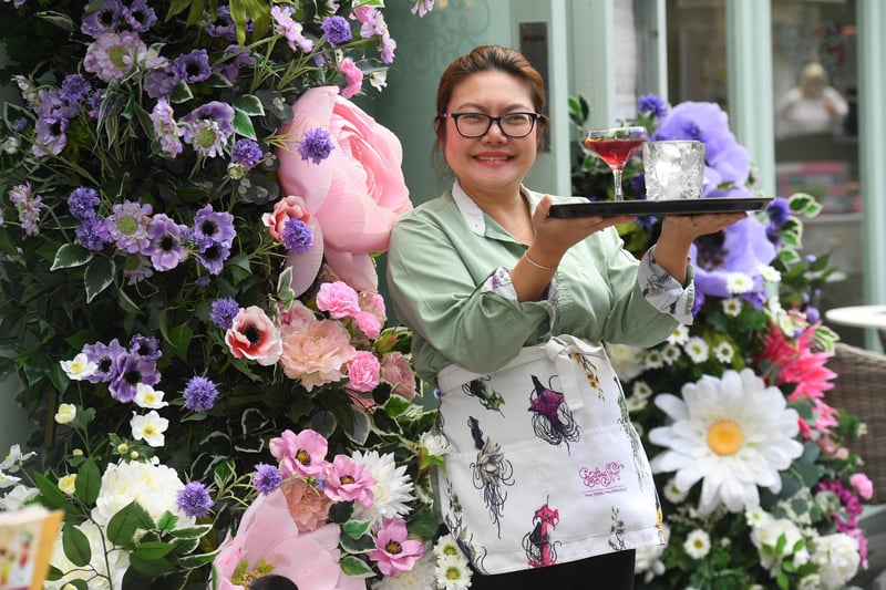Por Wilson of Giggling Squid with their flower arrangement which is entered into the shop window competition